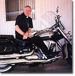 Father Joshua on a motorcycle